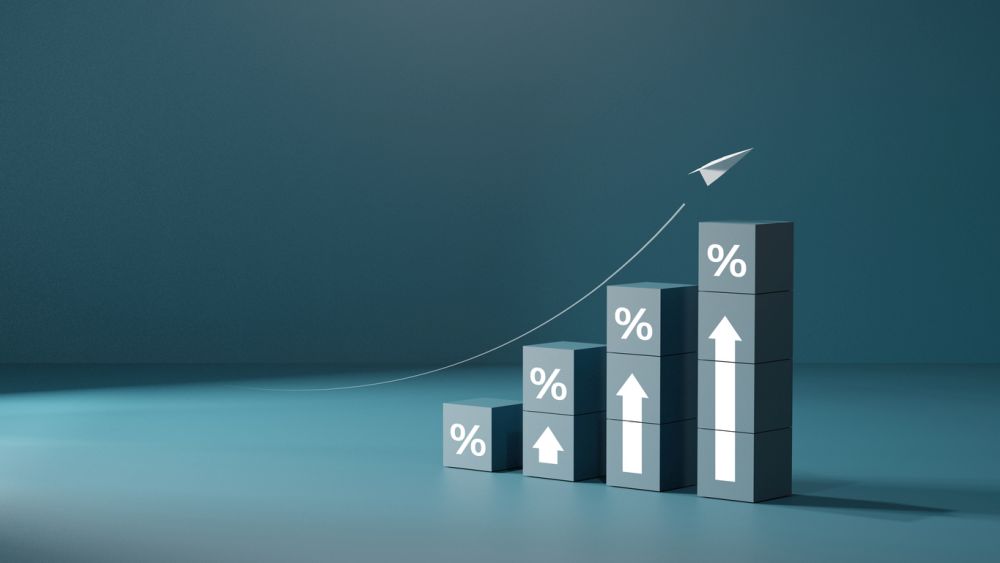 Wooden blocks with percentage signs showing an upward trend, concept of interest growth
