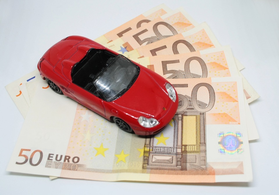 Red toy car in 50 Euro bills