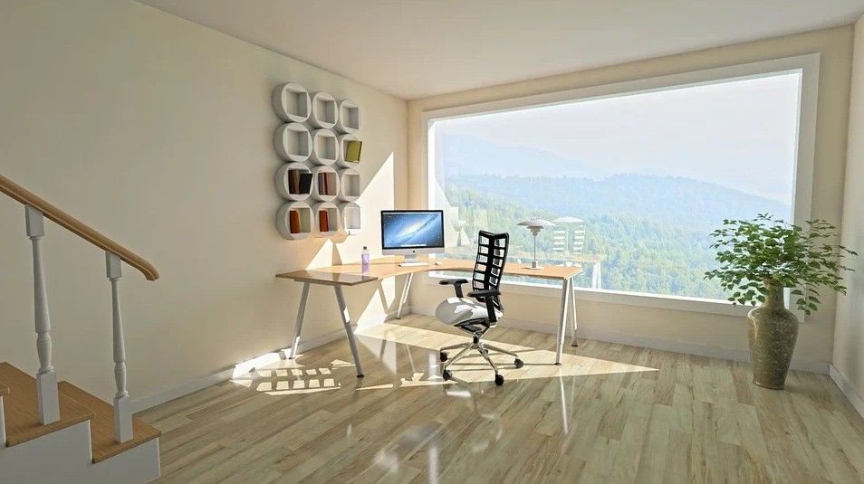 Corner desk in a room with a wide window