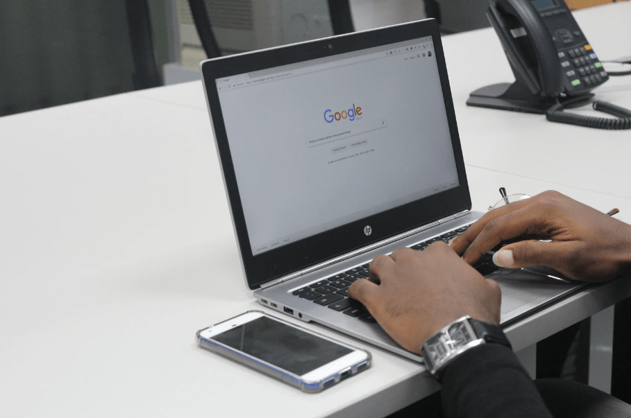 A person using the Google search engine on a laptop.