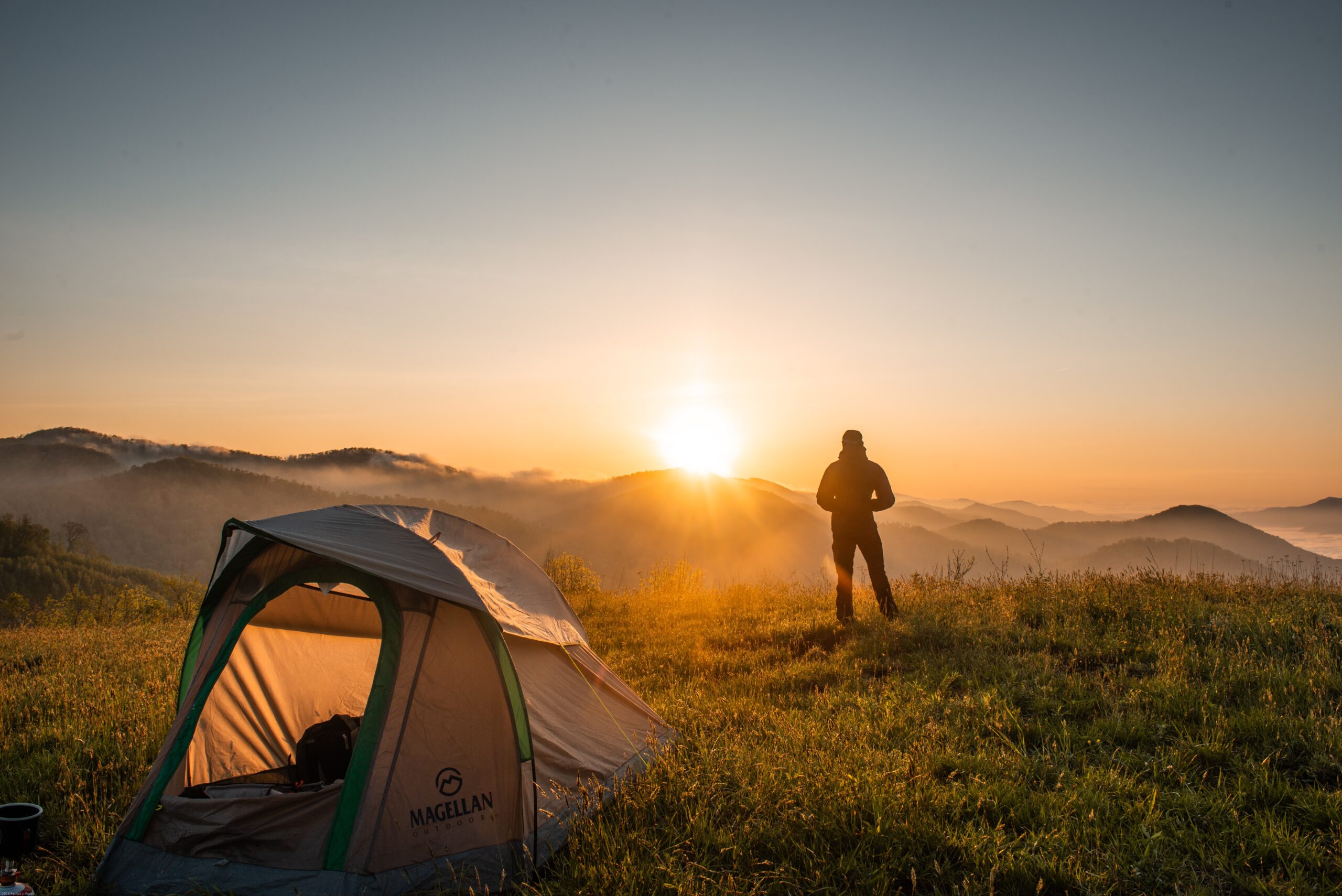 silhouette-of-person-standing-near-camping-tent
