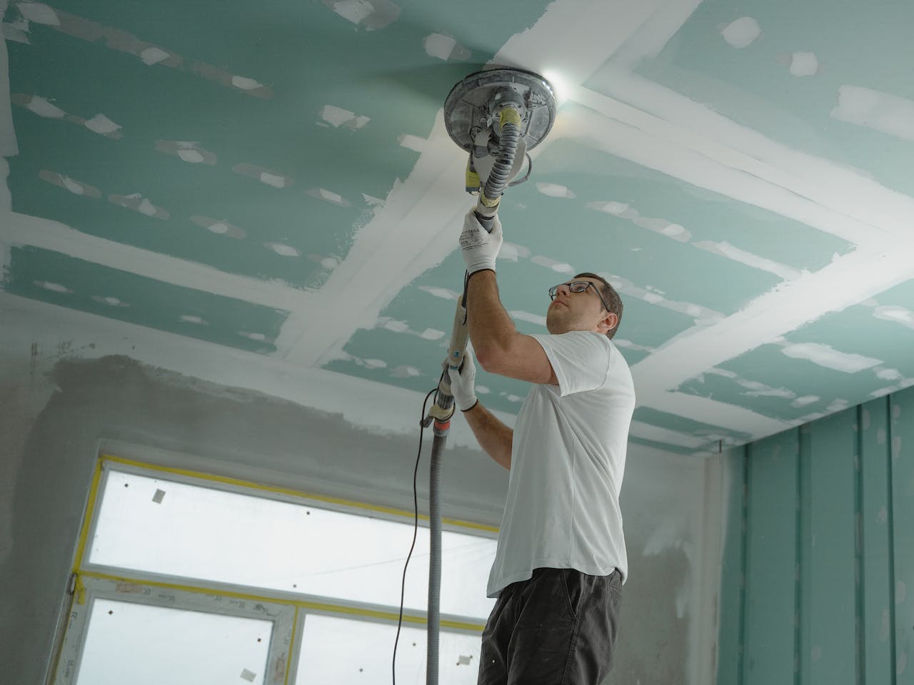 painter polishing ceiling